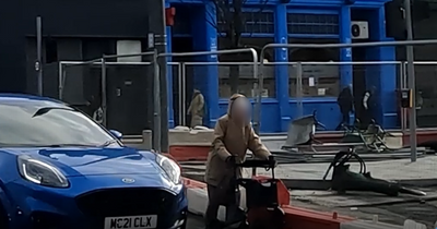 Edinburgh woman with a walker seen struggling through traffic and tram works