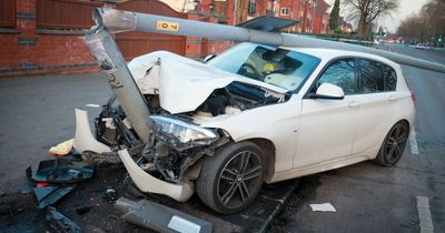 BMW crushed by street light as police hunt driver after smash