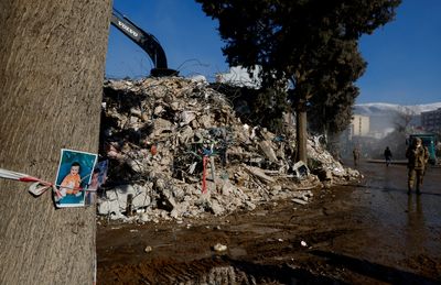 Photos tied to tree of missing boys highlight painful search for earthquake victims