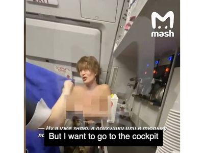 Topless Russian woman on flight demands entry to cockpit