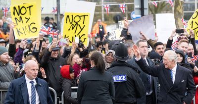 Charles comes face-to-face with protestors holding signs saying 'Not My King'