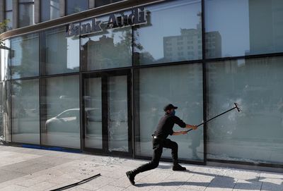 Protesters in Beirut smash banks as Lebanese pound spirals