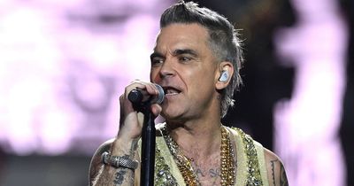 Robbie Williams left stunned as fan 'tried to eat him' on stage at concert