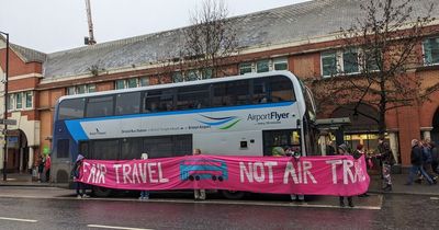 Extinction Rebellion activists surround Bristol Airport bus in transport protest