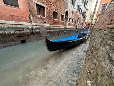 Prolonged low tides see smaller canals dry up in Venice