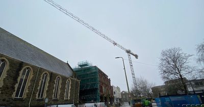 What's happening at Llanelli’s grand old YMCA building as a crane towers over the town centre