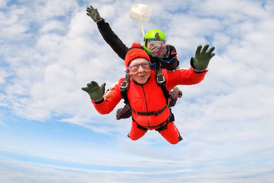 Man, 76, with prostate cancer completes 11,000ft skydive in memory of partner