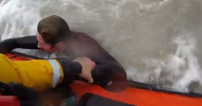 RNLI crew watched as teen boy in 'grave danger' was knocked from a rock before plucking him from huge swell