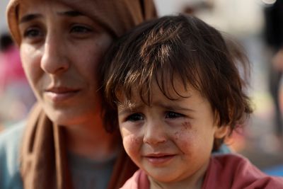 Children play, mother mourns: life grinds on in a Turkey camp