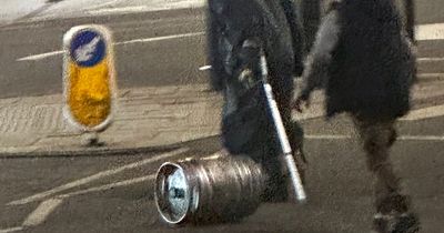 Odd moment Edinburgh man with crutch kicks full keg of beer down city centre street