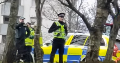 Armed police lock down street outside block of flats in Dundee