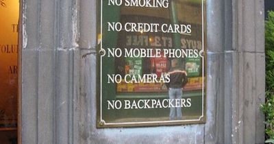 Tourists divided over 'unwelcoming' sign barring punters from Edinburgh pub