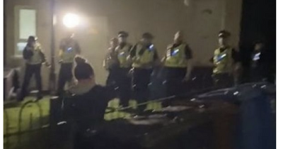 Angry scenes in Dumbarton as riot police pelted with bricks and fireworks as house attacked