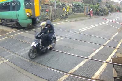 Footage shows moped narrowly avoiding 70mph train at level crossing