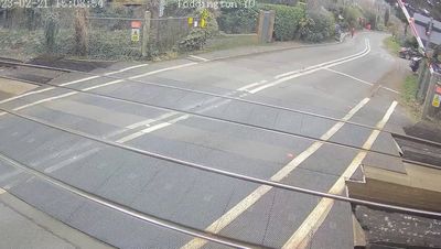Shocking moment moped narrowly misses 70mph train at level crossing