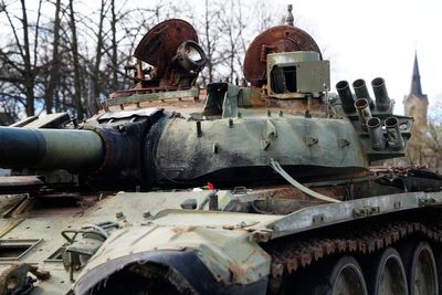 Russians place flowers at burnt out tanks in Baltic cities