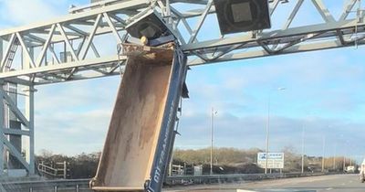 Tipper truck ends up vertical and wedged after crash that shuts motorway