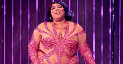 Lizzo looks stunning in semi-sheer sparkling pink leotard with see-through panels