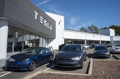 Tesla stock is down 50% from its high. Here's what to consider before buying