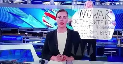 Woman who interrupted TV show to slam Putin's war shares daring escape from Russia