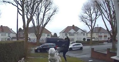 Thug caught on doorbell camera as he kicks little girl's snowman into pieces