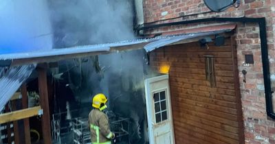 Woman in tears after five dogs pulled from house fire