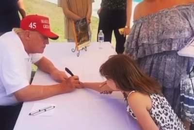 Video shows Trump signing girl’s hand at Mar-a-Lago