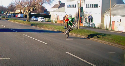 Reckless lout caught doing wheelie on dirt bike carrying child on Scots road