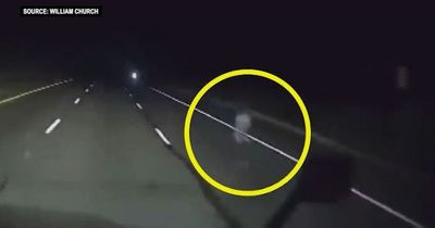 Moment creepy ghost-like figure spotted on road while trucker drives alone