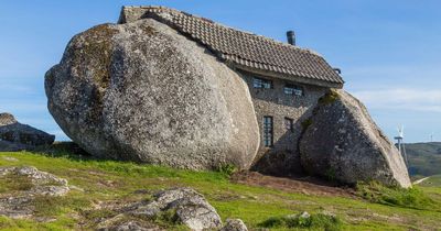 Real-life Flintstones house carved from four BOULDERS with pool and bulletproof windows