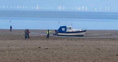 Search for occupants after police seal off boat found washed up on Welsh beach