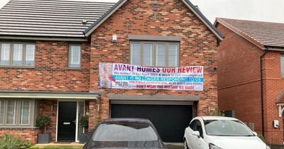 Man hangs huge banner outside £500,000 new build home in furious two-year row with developer