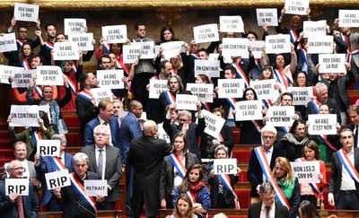 Macron survives no-confidence vote but strikes and protests to continue across France