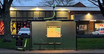 Yellow Nottingham e-scooter 'parked' on top of bus shelter