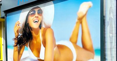 Tanning salon boss ordered to take down 'offensive' poster showing woman in a bikini