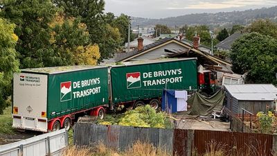 Truck driver dies and two others injured as truck hits car and then ploughs into Launceston house