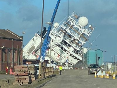 Dozens injured as huge ship topples over in dry dock during strong winds