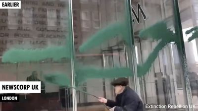 Extinction Rebellion spray London newspaper offices with green paint in climate coverage protest