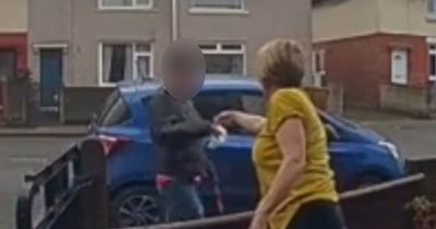Woman hands bag of dog mess to neighbour who let pooch do its business in her garden