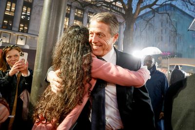 Hugh Grant smiles and hugs fans at Dungeons and Dragons premiere after Ashley Graham interview