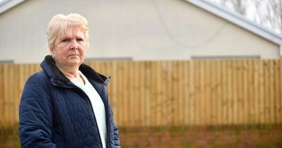 Neighbours face legal action after council order them to decrease height of their fences