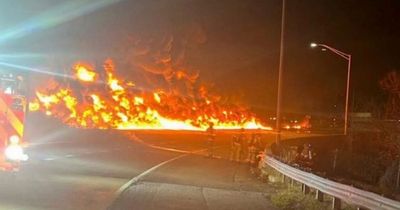 Massive blaze erupts as tanker truck overturns and explodes on busy highway