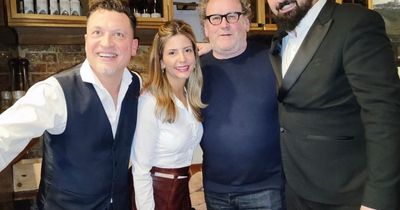 Colm Meaney beams as he poses for pic with staff in Dublin restaurant