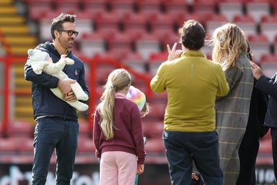 Ryan Reynolds and Blake Lively pose for photos with their newborn at Wrexham game