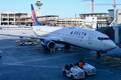 Delta passenger arrested for opening plane door then escaping down inflatable slide as plane prepared for takeoff