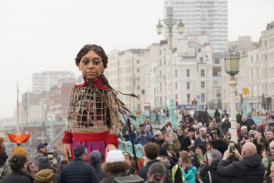 Giant puppet Little Amal leads walk in Brighton to raise awareness of refugees