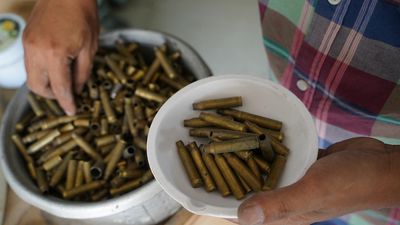 Cambodian goldsmith turns bullet casings into jewellery to promote world peace