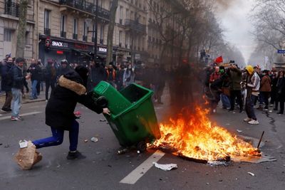 Embattled Macron heads to China, leaving burning Paris behind