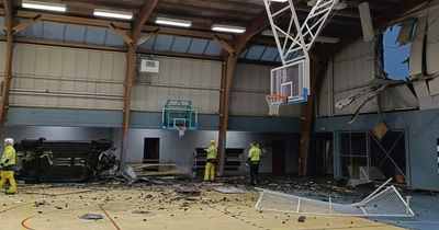 Footballer crashes car through wall of sports hall and rushed to hospital