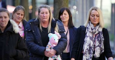 Cheryl Korbel carries teddy bear made of Olivia's pyjamas into court